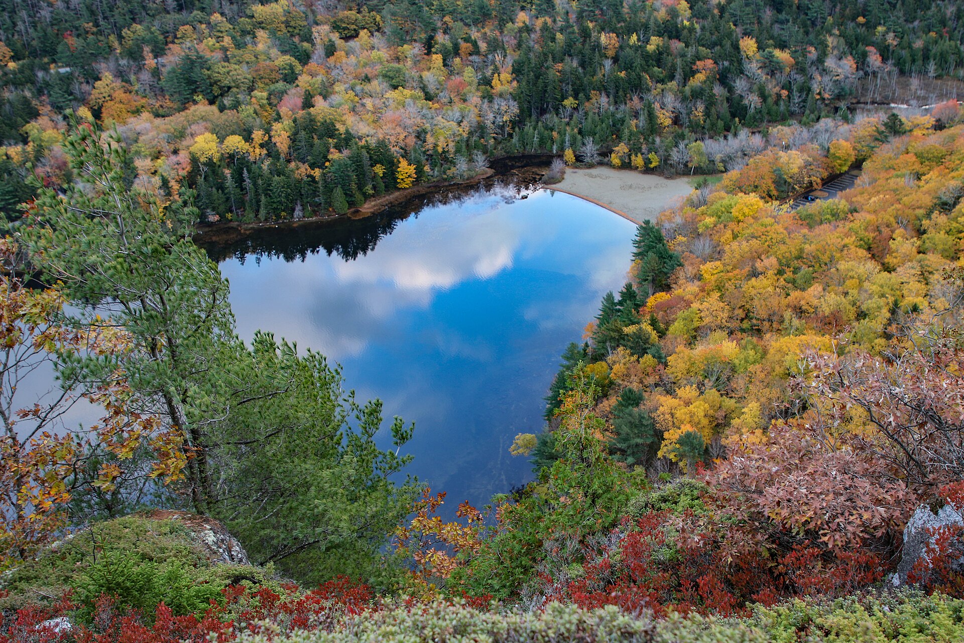 Acadia, Maine — Autumn hardwood ringing a mountain pond from the granite rim