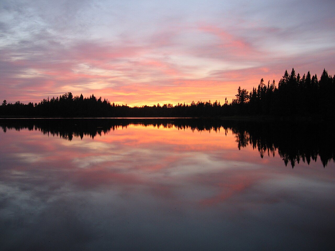 Sunset fire along a wilderness lake shore