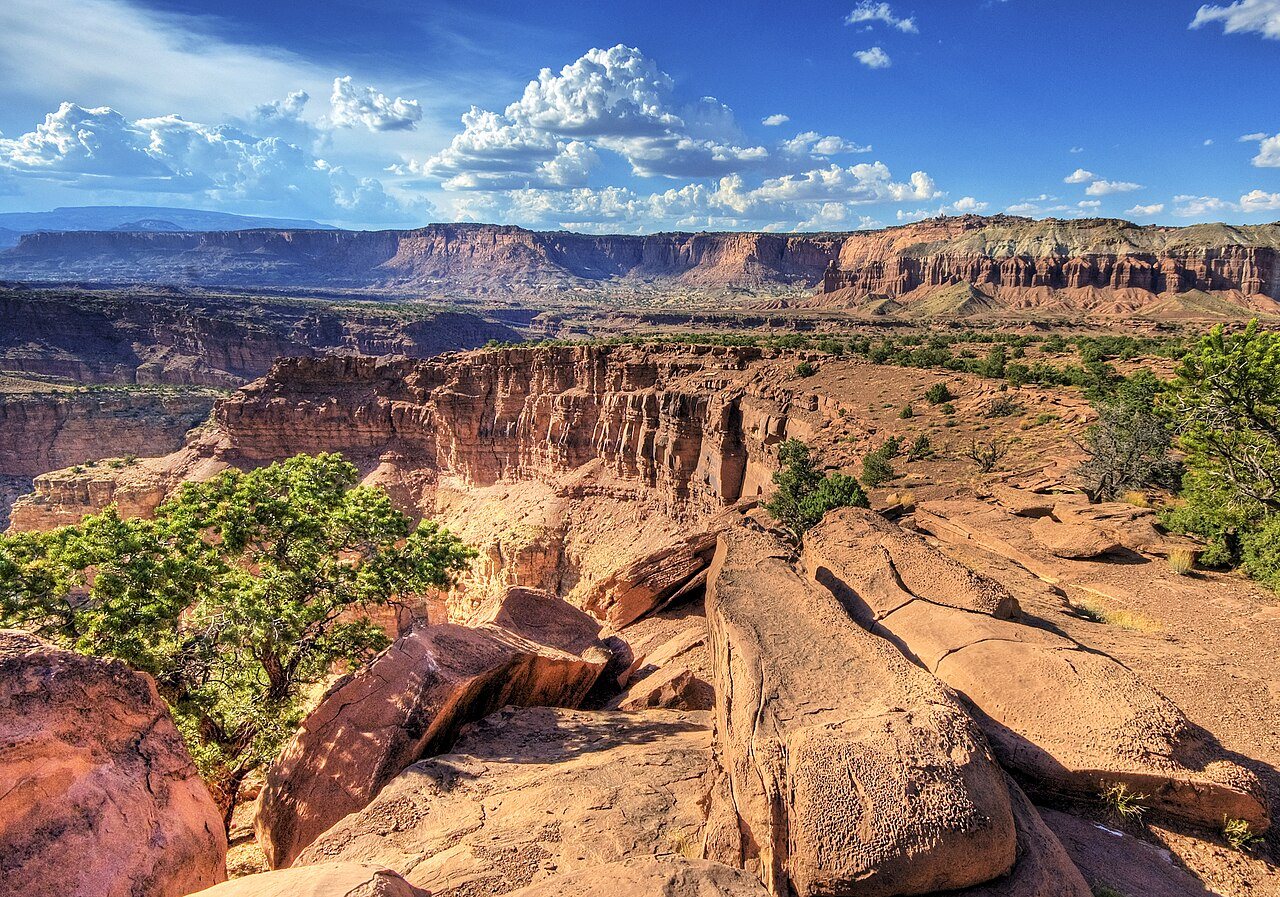 Castle cliffs glowing above a dark desert foreground