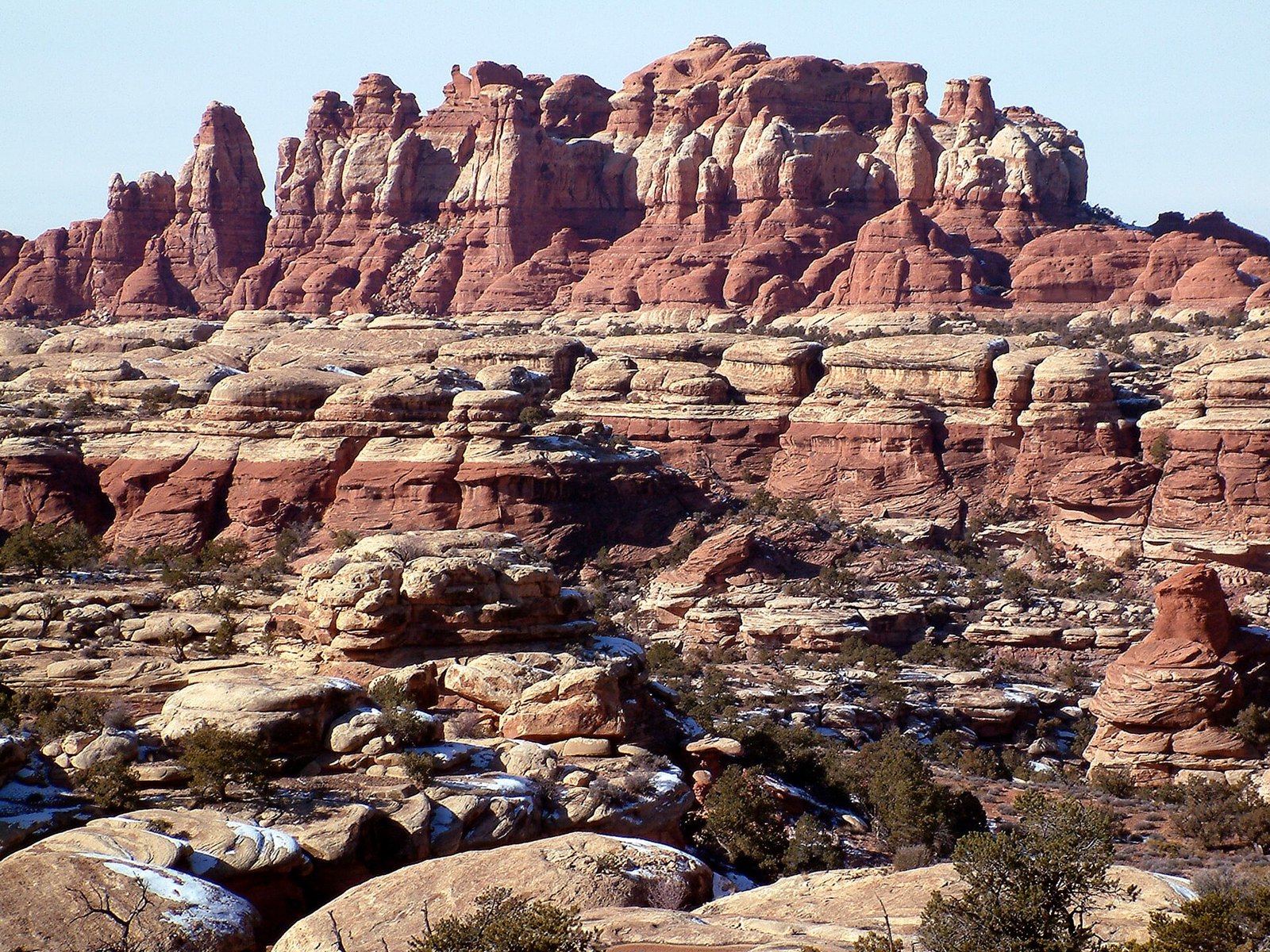 Red-and-white Needles standing in a stone city