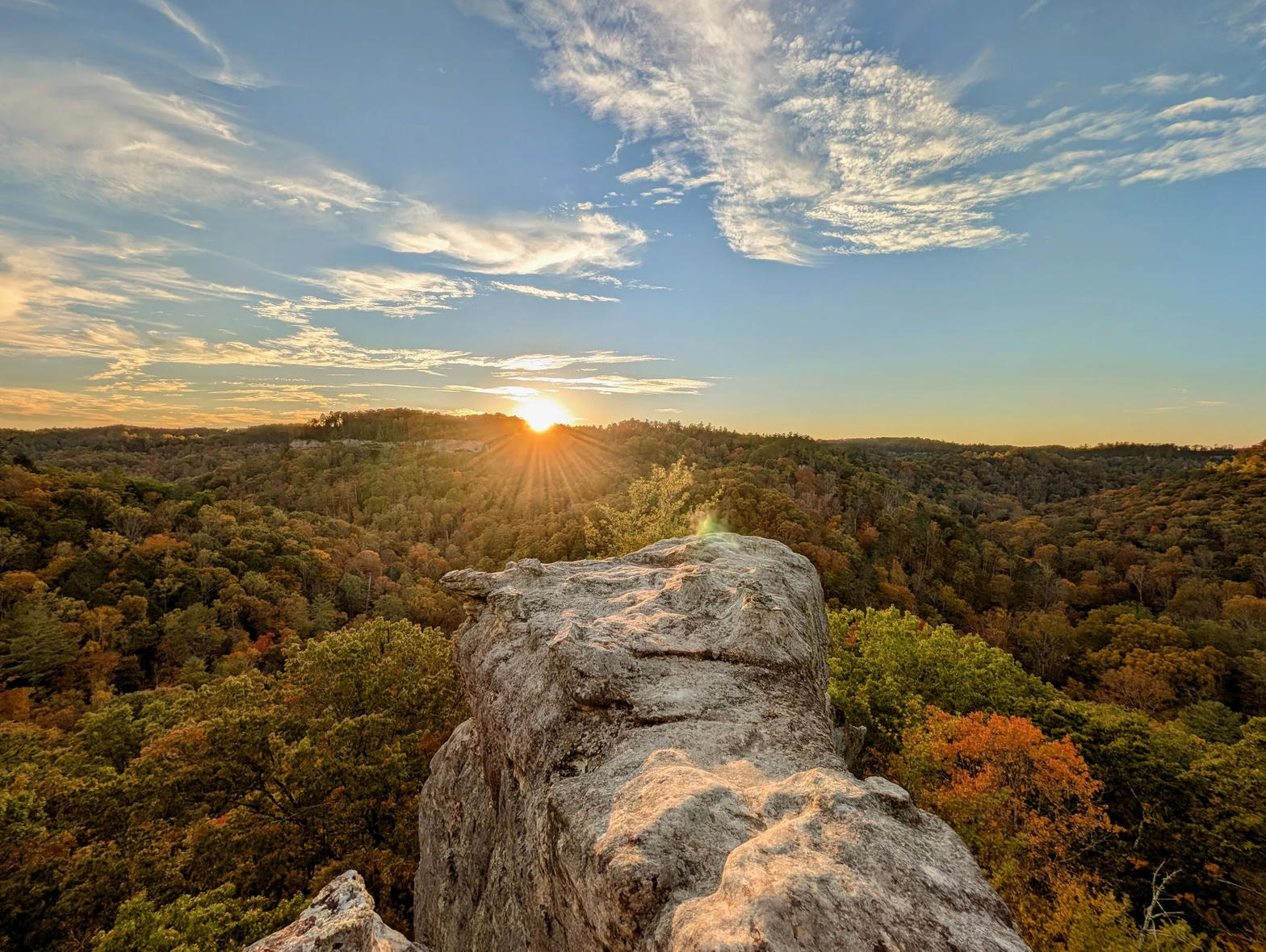 A sandstone prow over autumn hardwood