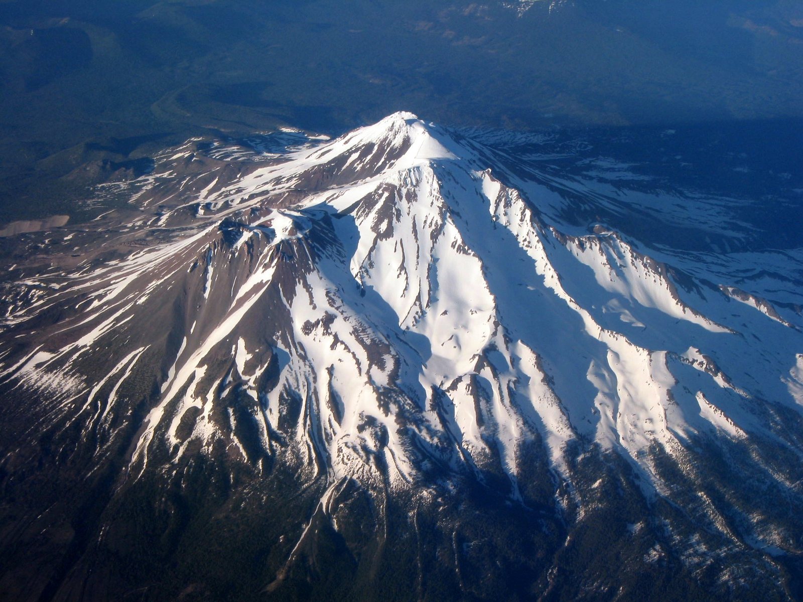 The solitary cone above its own forested base