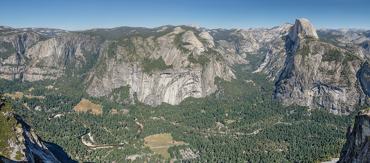 Yosemite Falls dropping through sunlit valley pines